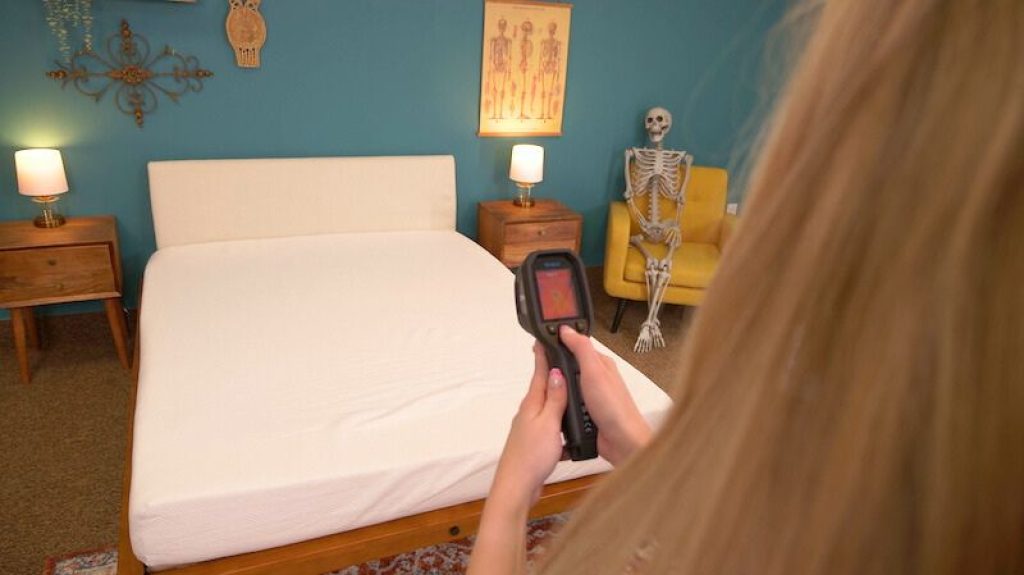 Julia Forbes testing how fast a mattress cools down