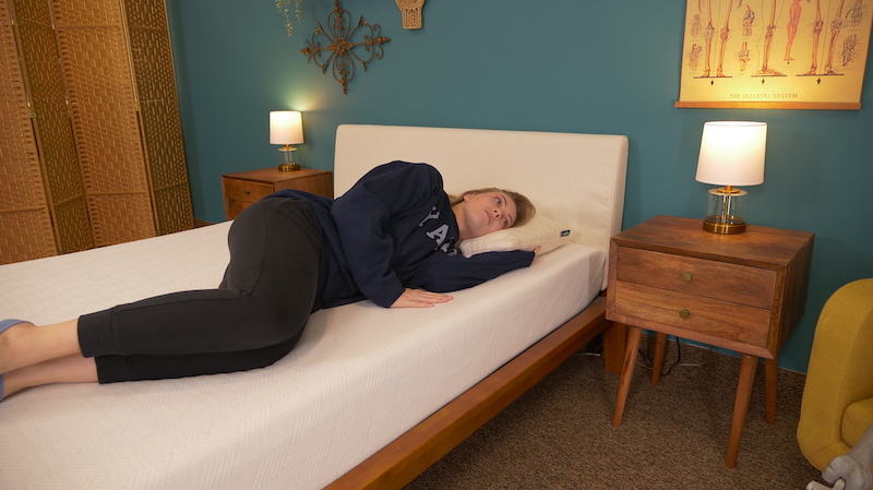 Julia Forbes testing a mattress for side sleeping